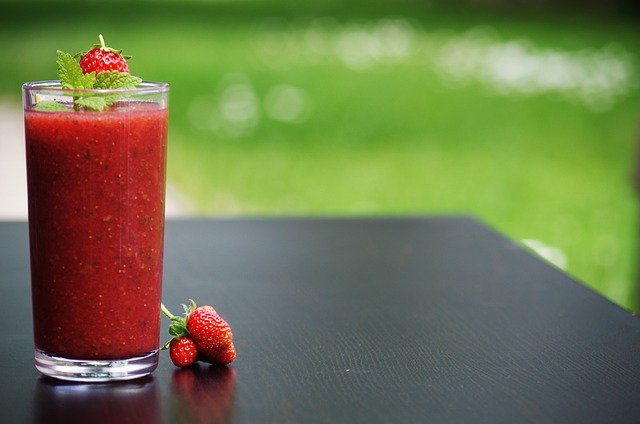 beautifully prepared glass of strawberry smoothie on a table